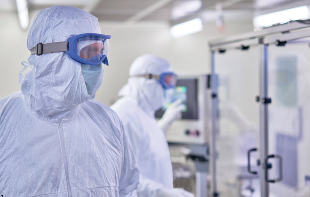 workers wearing sterile tyvek isoclean coveralls in a environment