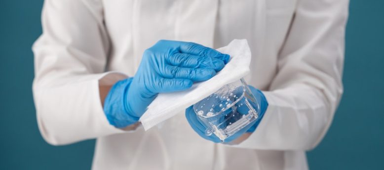 cleanroom working disinfecting goggles with a lint-free wipe and sterilant solution