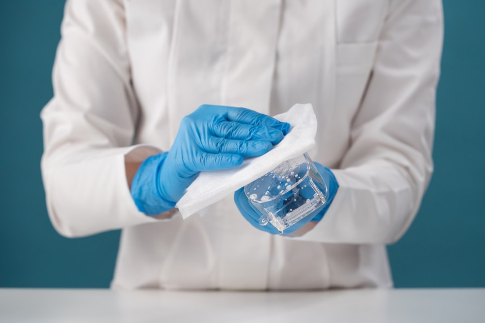 cleanroom working disinfecting goggles with a lint-free wipe and sterilant solution