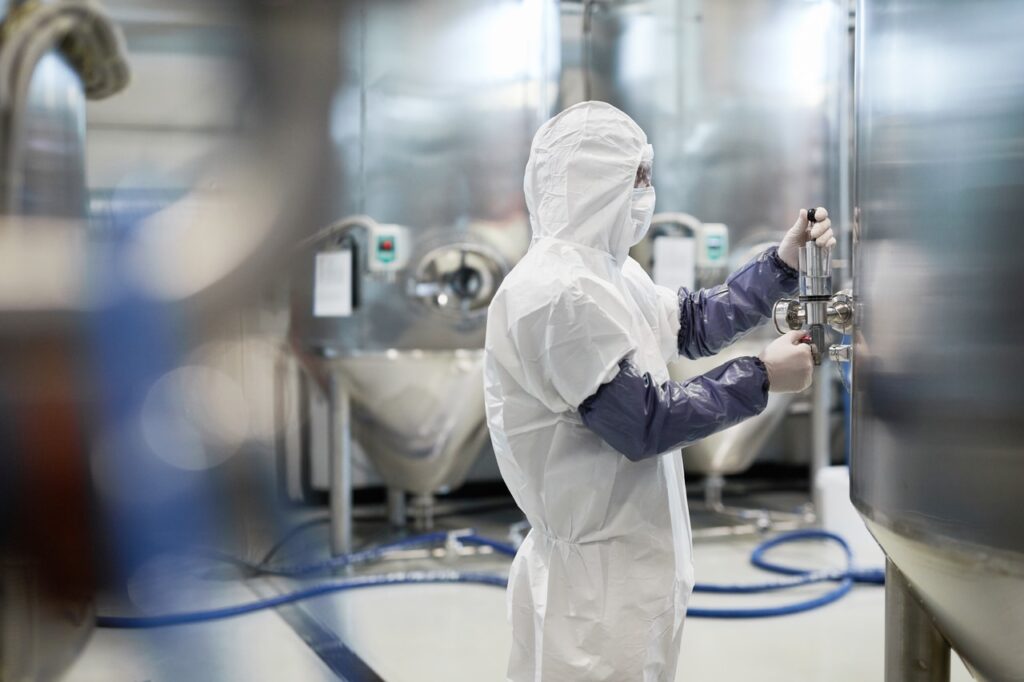 pharmaceutical cleanroom worker in full cleanroom protective apparel