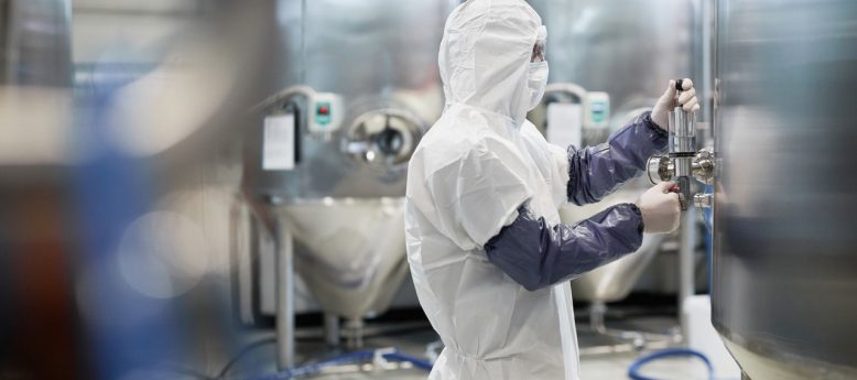 pharmaceutical cleanroom worker in full cleanroom protective apparel