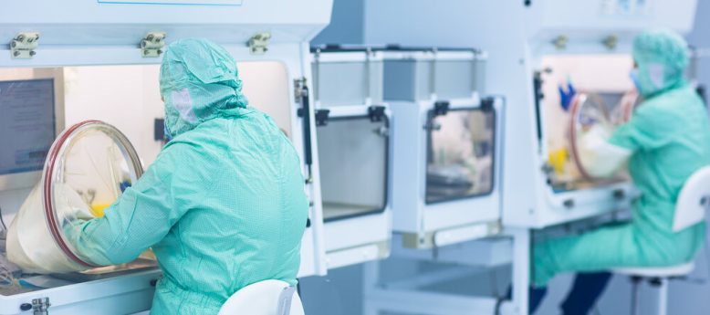 Pharmaceutical technician in sterile environment working on prod