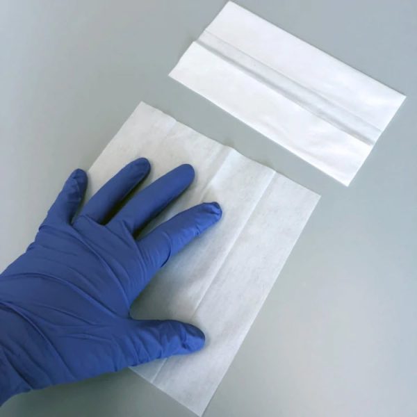 gloved hand wiping a surface with a free-sat nonwoven poly-cellulose 99% ipa presaturated wipe