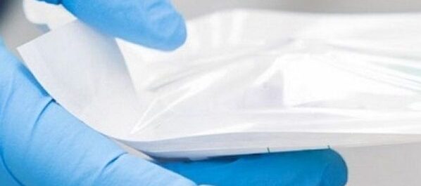 cleanroom bag being used in a cleanroom by a worker with a gloved hand