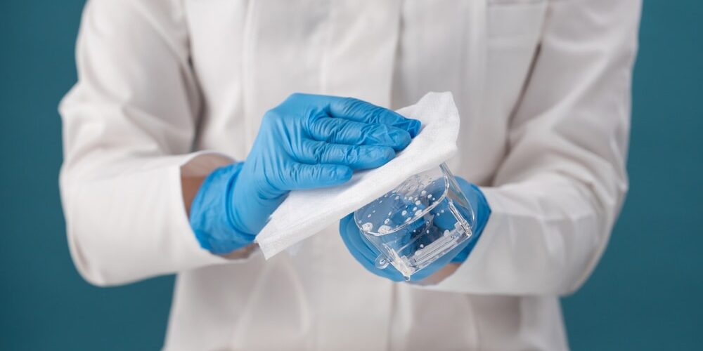 cleanroom working disinfecting goggles with a lint-free wipe and sterilant solution