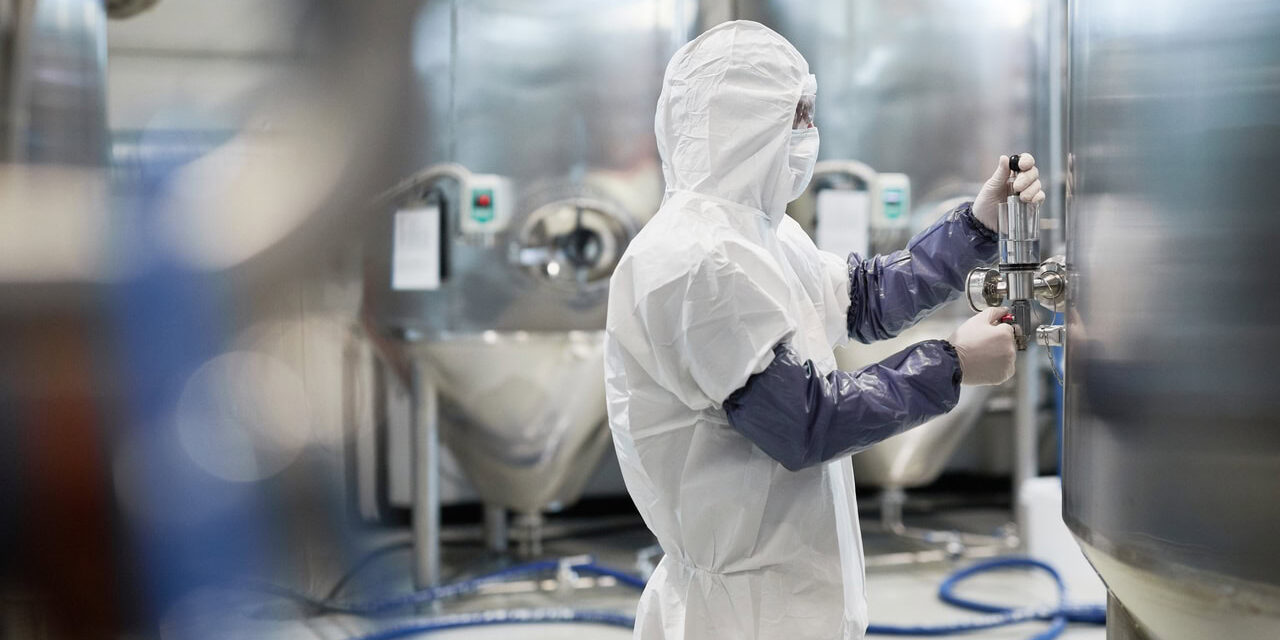 pharmaceutical cleanroom worker in full cleanroom protective apparel